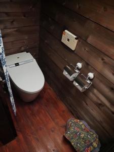 a bathroom with a toilet in a wooden wall at Kominka Washinkan - Vacation STAY 13791 in Yaita