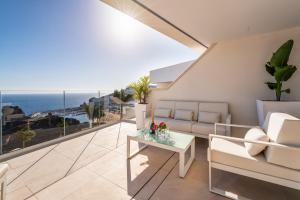 a living room with a view of the ocean at Grand Horizon Luxury Boutique Apartments in Puerto Rico de Gran Canaria