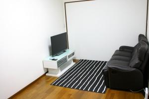 a living room with a chair and a flat screen tv at RETRO retro - Vacation STAY 03865v in Azagawa