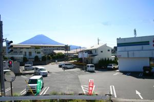 a parking lot with cars parked in front of a building at RETRO retro - Vacation STAY 03865v in Azagawa