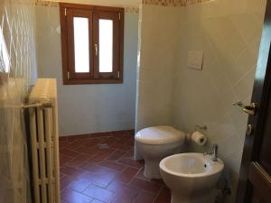 a bathroom with a toilet and a sink at Podere La Cerraia in Serravalle Pistoiese +32 photos