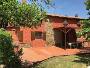 a house with a patio in front of it at Podere La Cerraia in Serravalle Pistoiese