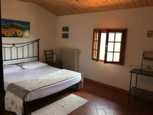 a bedroom with a bed and a window at Podere La Cerraia in Serravalle Pistoiese