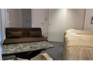 a living room with a couch and a table at Hotel Wisteria NARA - Vacation STAY 99258v in Nara
