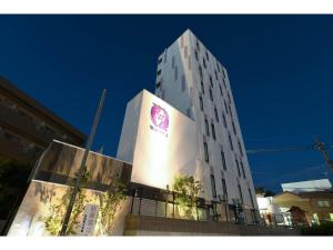 a tall white building with a sign on it at Hotel Wisteria NARA - Vacation STAY 99258v in Nara