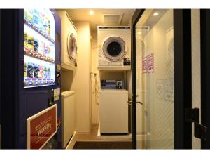 a small bathroom with a refrigerator and a microwave at Hotel Wisteria NARA - Vacation STAY 99258v in Nara
