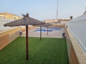 a group of umbrellas on a balcony with a pool at Monte Mar Apartment in Gran Alacant