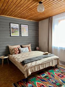 a bedroom with a bed and a window and a rug at Садиба Рокса in Slavske