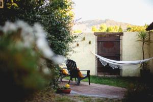 a bench sitting in a yard with a hammock at Porto Natura Loft in Valongo