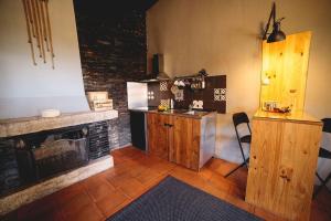 a kitchen with a stove and a fireplace at Porto Natura Loft in Valongo