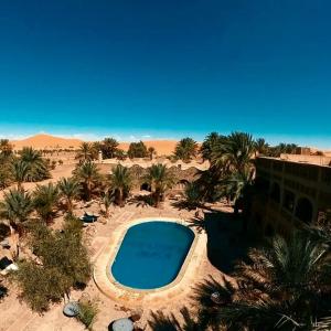 an overhead view of a swimming pool in the desert at Hotel ksar merzouga in Merzouga