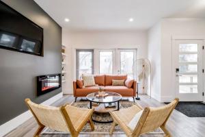 a living room with a couch and a table at Chic Retreat, 4BR Near DT & WEM, Fireplace, Trails, Sleeps 10! in Edmonton