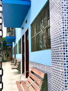 a row of benches sitting next to a building at Residencial Albatroz in Caraguatatuba