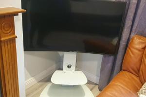 a large computer monitor sitting on top of a couch at Modern house in Dublin in Dublin