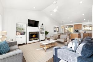 a living room with a couch and a fireplace at Seas The Day in Seaside