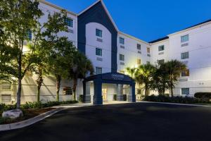 a large white building with a blue entrance at Candlewood Suites - Bluffton-Hilton Head, an IHG Hotel in Bluffton