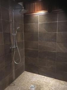 um chuveiro na casa de banho com uma parede em azulejo em Secret little hideaway - with proximity to Oxford em Cassington