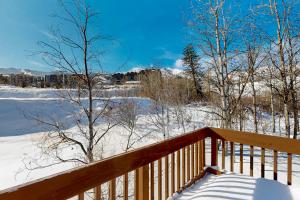 a wooden deck with snow on the ground at Hidden Creek Retreat in Park City