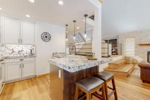 a kitchen with a large island and a living room at Hidden Creek Retreat in Park City