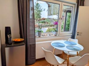 a kitchen with a table and chairs and a window at Ferienwohnung 50m2 in Hilchenbach
