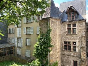 un antiguo edificio de piedra con una torre con techo en Charmant appartement - centre Cité Plantagenet!!!, en Le Mans