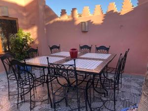 a table and chairs sitting on a patio at riad rose eternelle in Marrakesh