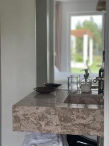 a kitchen with a marble counter top with a window at Casa da Courela in Cavaleiro