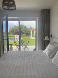 a bedroom with a bed and a dog looking out the door at Casa da Courela in Cavaleiro