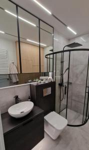 a bathroom with a toilet and a shower and a sink at Magic House Apartament Proszowska 58 in Bochnia