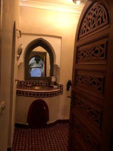 a room with a door with a mirror and a fireplace at riad rose eternelle in Marrakech