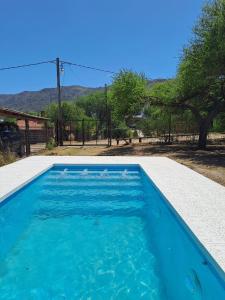 a blue swimming pool with a view of the mountains at CABAÑA LA HERRADURA 14 in San Roque