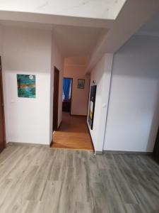 an empty room with white walls and wood floors at Casa do Paço in Almeirim