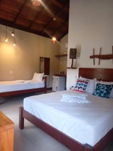 a bedroom with two beds in a room at POUSADA RANCHO PARAISO in Pôrto de Pedras