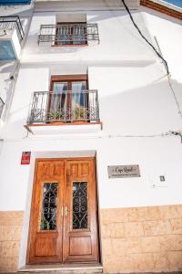 a building with a wooden door and two windows at Casa Rural - Apartments 4 you - La Nucia in La Nucía