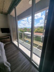 a room with a large window with a view of a building at BEM Apartamento in Salta