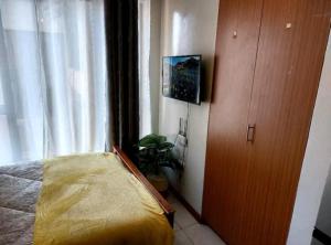 a bedroom with a bed next to a window at Quiet and affordable home in Kikuyu