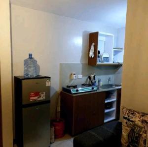 a small kitchen with a sink and a refrigerator at Quiet and affordable home in Kikuyu
