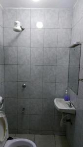 a bathroom with a toilet and a sink at Quiet and affordable home in Kikuyu