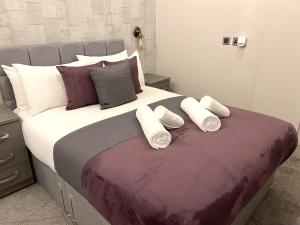 a bedroom with a large bed with three pillows at Brand New SILVER FORGE - Charming Two Bedroom Apartment - City Centre - Lux Apartment in Birmingham