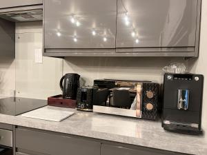 a kitchen counter with a toaster oven and a microwave at Brand New SILVER FORGE - Charming Two Bedroom Apartment - City Centre - Lux Apartment in Birmingham