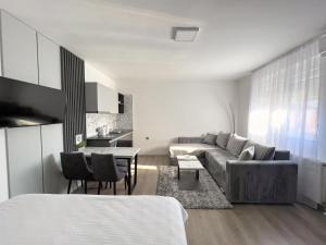 a living room with a couch and a table at Hany Sweet in Niš
