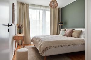 a bedroom with a bed and a large window at Designer Apartments in Smíchov by Prague Days in Prague