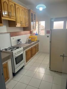 a kitchen with a stove and a refrigerator at Agadir Dreamhouse in Agadir