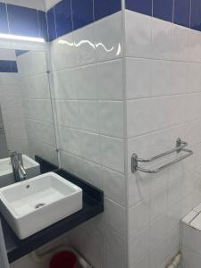 a white bathroom with a sink and a toilet at Agadir Dreamhouse in Agadir +4 photos