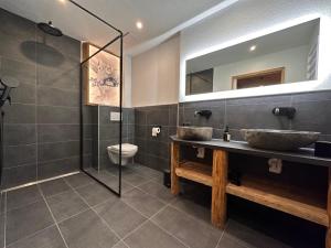 a bathroom with two sinks and a shower at Chalet Schwarz in Berwang