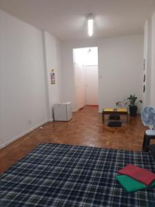 an empty living room with a rug on the floor at Apê Minimalista Melhor do Centro Self check-in in Rio de Janeiro