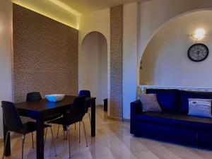 a living room with a table and a couch at Villa Pignatelli in Bari