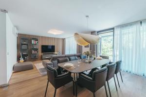 a dining room and living room with a table and chairs at Stylish Apartments in Braník by Prague Days in Prague