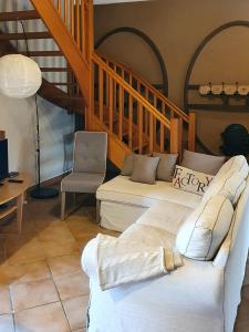 a living room with two beds and a staircase at Domaine de la Brette in Condom
