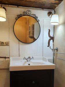 a bathroom with a sink and a mirror on the wall at Domaine de la Brette in Condom